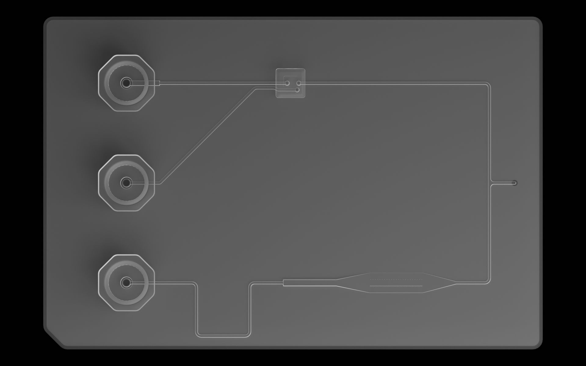 Top view of the reference device. On top of the fluidic layer sits three ports to the left and a microvalve near the center.